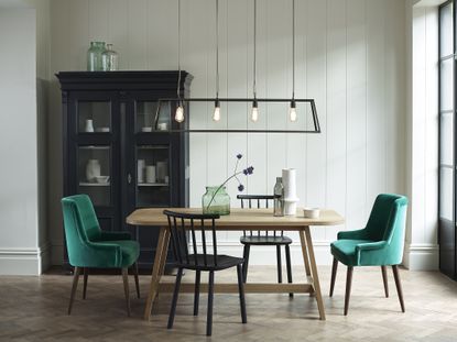 white dining room with green chairs and industrial black pendant light by Davey