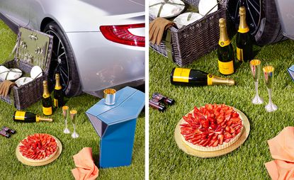 Picnic basket, champagne, glasses and Strawberry tart next to an Aston Martin
