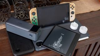 An Anker Prime battery pack, Viture Mobile Dock, Nintendo Switch, Onyx Boox Page, and Honor MagicPad 2 together