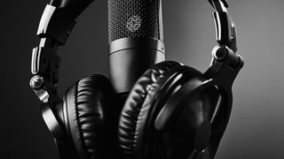 Close up shot of a headphones and a microphone in black and white