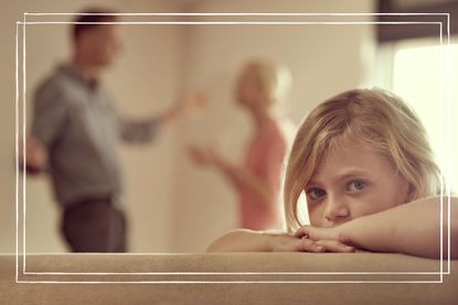 Shot of a little girl looking unhappy as her parents argue in the background