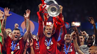 Virgil van Dijk of Liverpool lifts the UEFA Champions League trophy, 2019.