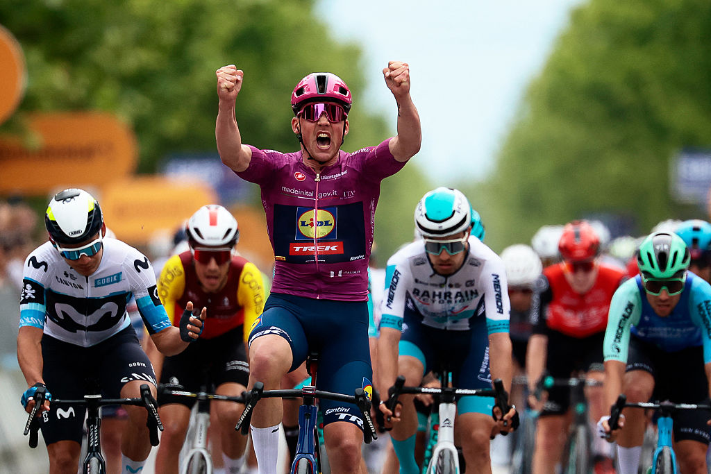 Lidl-Trek's Danish rider Mads Pedersen (C) wearing the points classification mauve jersey (Maglia Ciclamino) celebrates as he crosses the finish line to win the 3rd stage of the 108th Giro d'Italia cycling race, 160km from Vlore to Vlore in Albania, on May 11, 2025. (Photo by Luca Bettini / AFP)