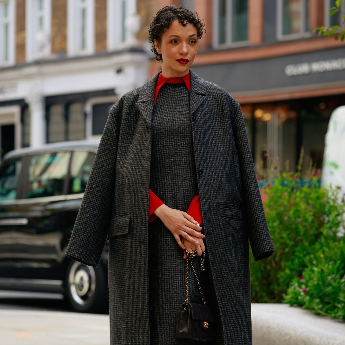 a woman wearing a knitted work dress and matching coat during london fashion week