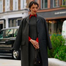 a woman wearing a knitted work dress and matching coat during london fashion week