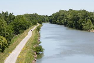 A walking path runs along what was once the towpath along the Erie Canal.