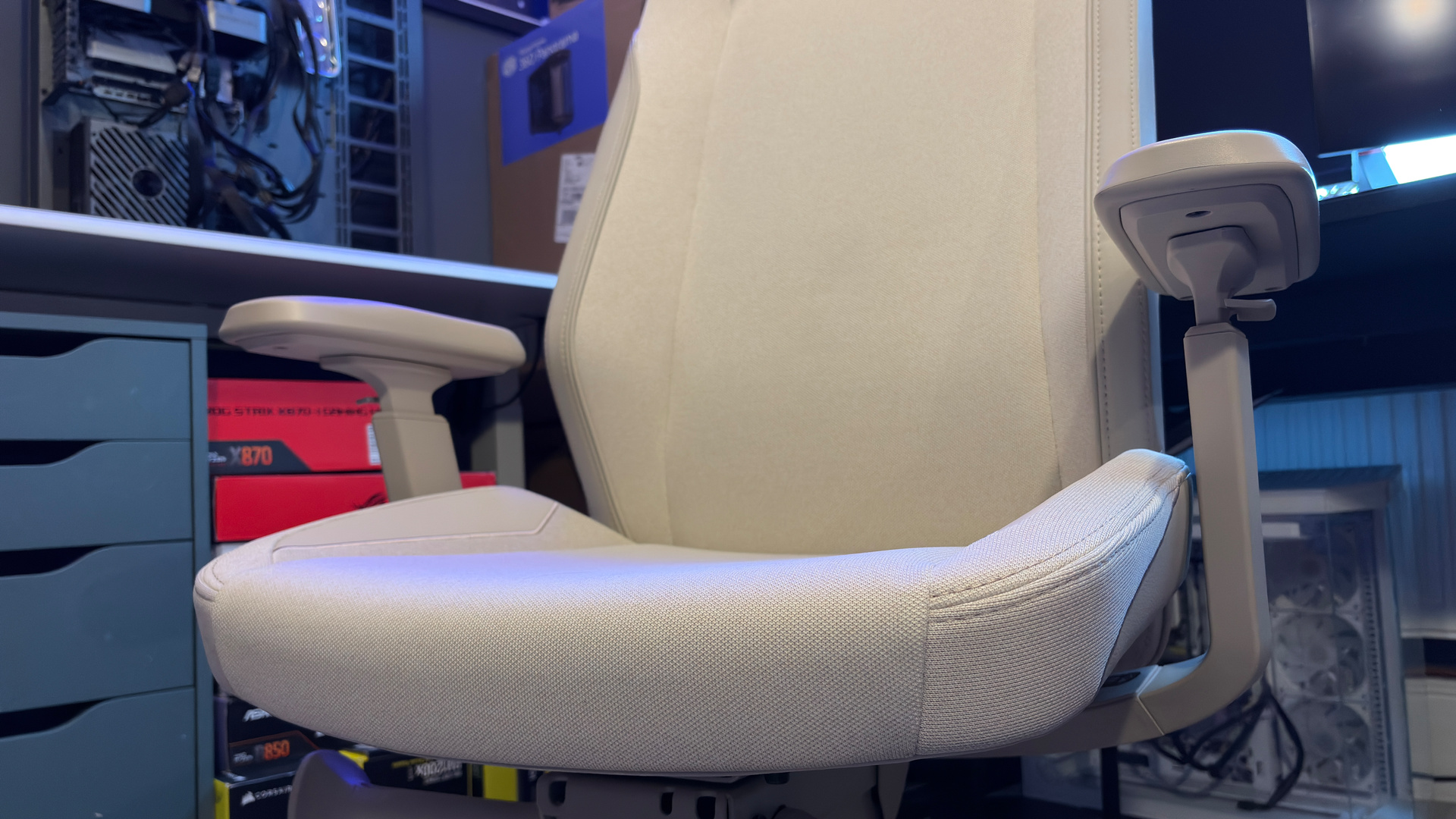 A Secretlab Atlas gaming chair in a home office during set-up and after it's completed.