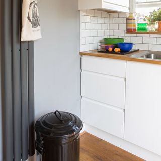 Corner of a kitchen with a bin