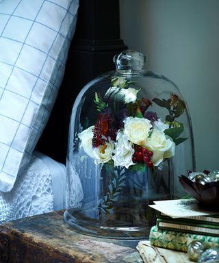 Christmas bedroom decor ideas with bedside flowers in glass cloche