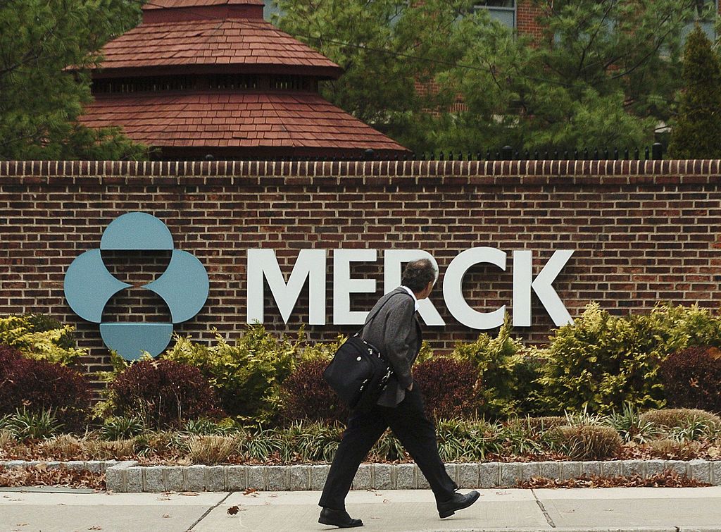 Man walks past Merck plant.