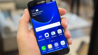 Samsung Galaxy S7 in hand, showing display