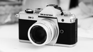 Black-and-white photo of the OM System OM-3 with the Mitakon Speedmaster 50mm f/0.95