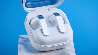the samsung galaxy buds 4 photographed against the blue tom's guide background showing charging case and buds