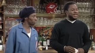 Eddie Griffin and Malcolm-Jamal Warner standing in front of a bar on Malcolm & Eddie