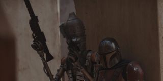 Mando and a droid getting ready for battle
