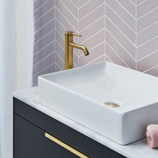 hite rectagular sink with brass tap on the side