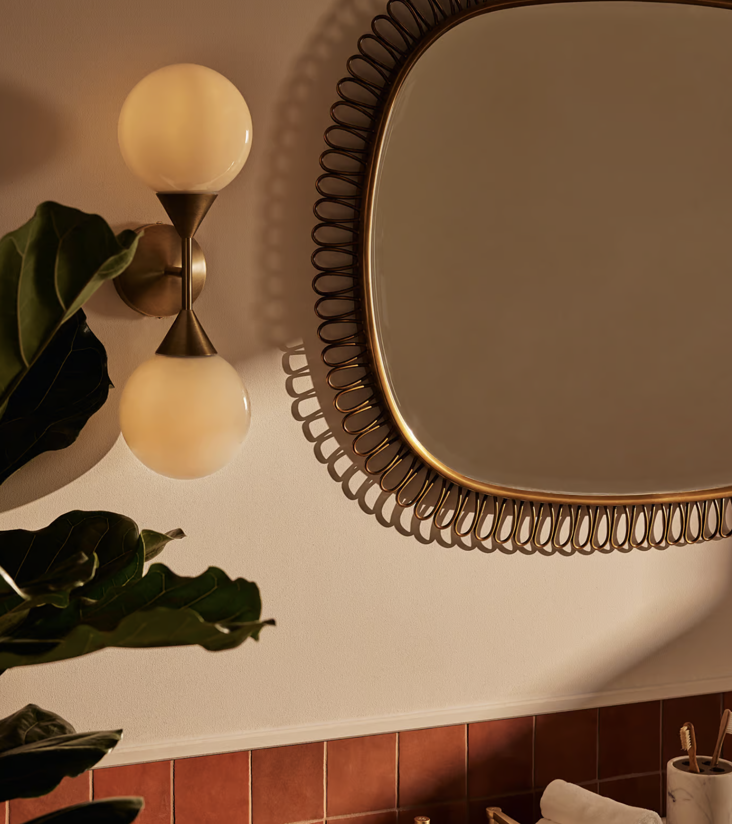 a double sided bathroom wall light next to a mirror