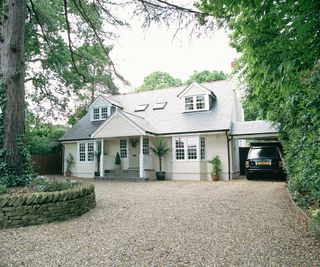 Gravel driveway leading up to the front of a converted bungalow