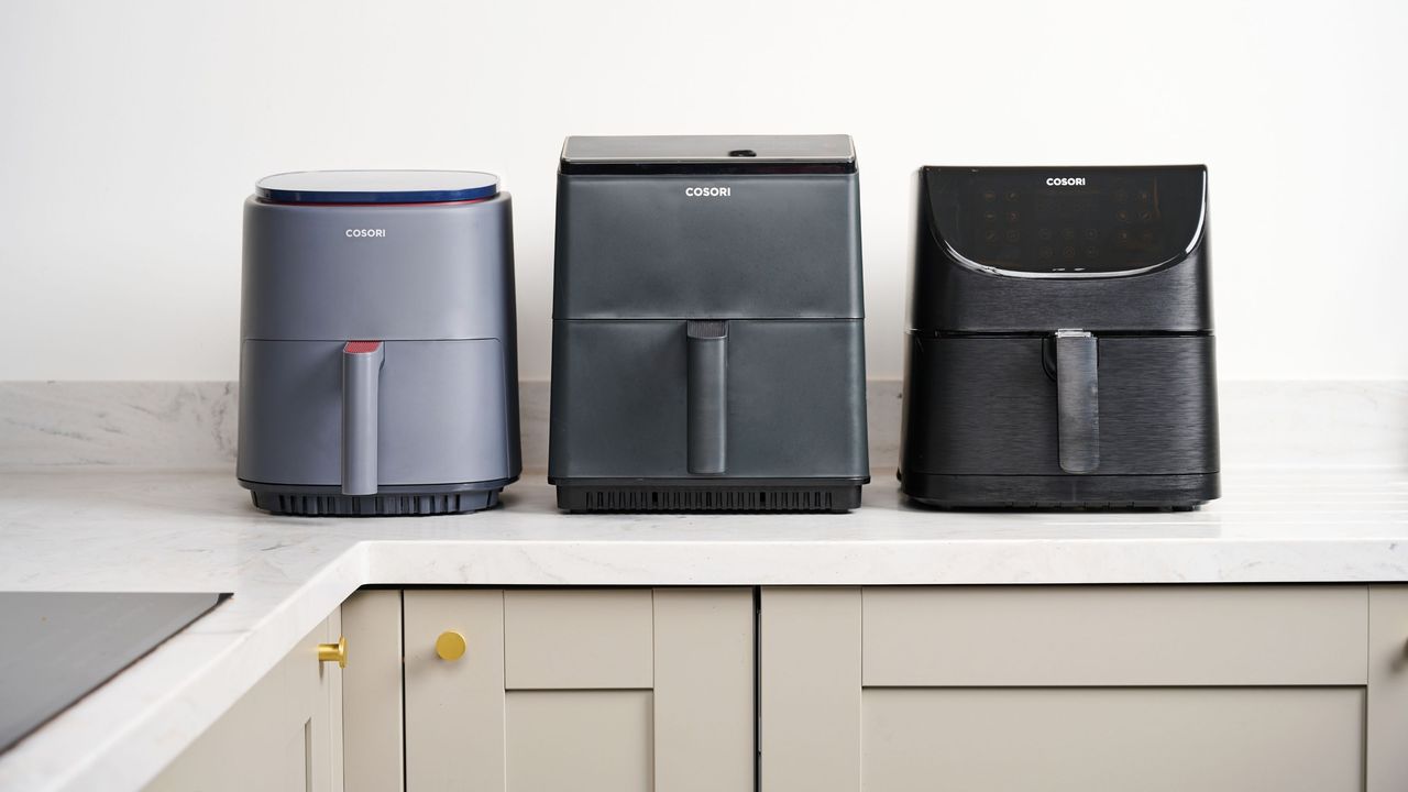 Three cosori air fryers lined up on the kitchen counter