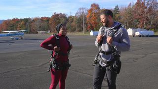 Ashley Adionser and Tyler Francis wear parachute harnesses before going skydiving, in 'Love is Blind' season 7.