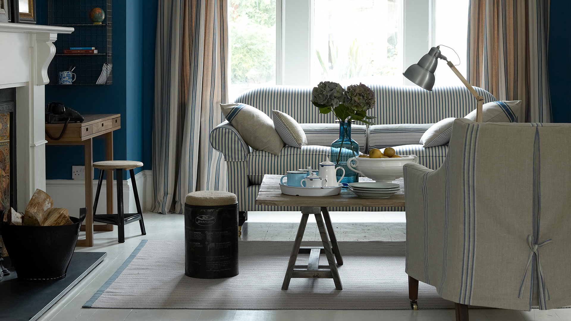 Blue living room with taupe fabrics and upholstered furniture