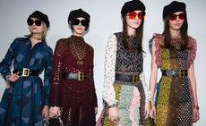 Models wear patched and knitted dresses with large size waist belts, ivy caps and sunglasses