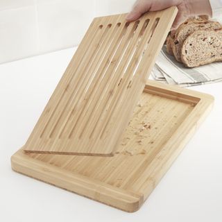 Close up of a wooden cutting board with a removable grate