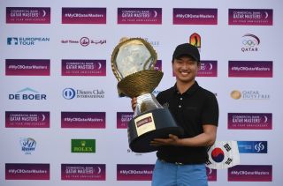 Wang holds the Qatar Masters trophy in 2017