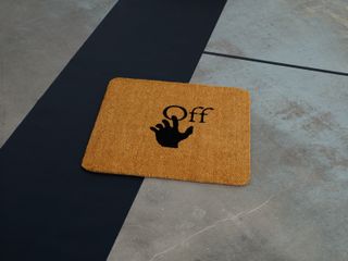 Off-White’s interiors line logo on a brown carpet