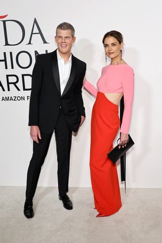 Katie Holmes poses on the cfda awards red carpet in a carolina herrera gown