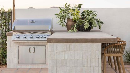 a white tiled outdoor kitchen