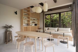 Café interior with pale wood table and chairs at Maana Kiyomizu, a Kyoto hotel