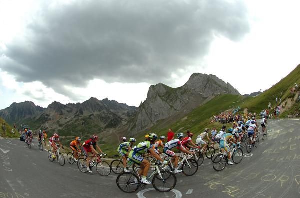 The main peloton works its way up the climb.