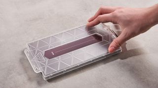 Person placing application frame onto the DBrand Prism 2.0 for Nintendo Switch 2