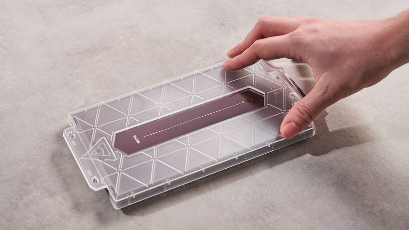 Person placing application frame onto the DBrand Prism 2.0 for Nintendo Switch 2