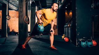 Man performs single-arm row with kettlebell