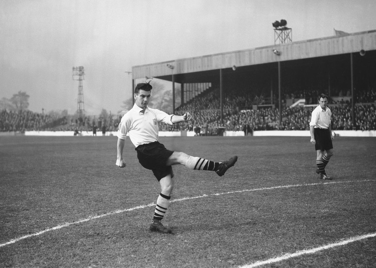 Johnny Haynes of Fulham warms up ahead of a match against Doncaster Rovers, 1955