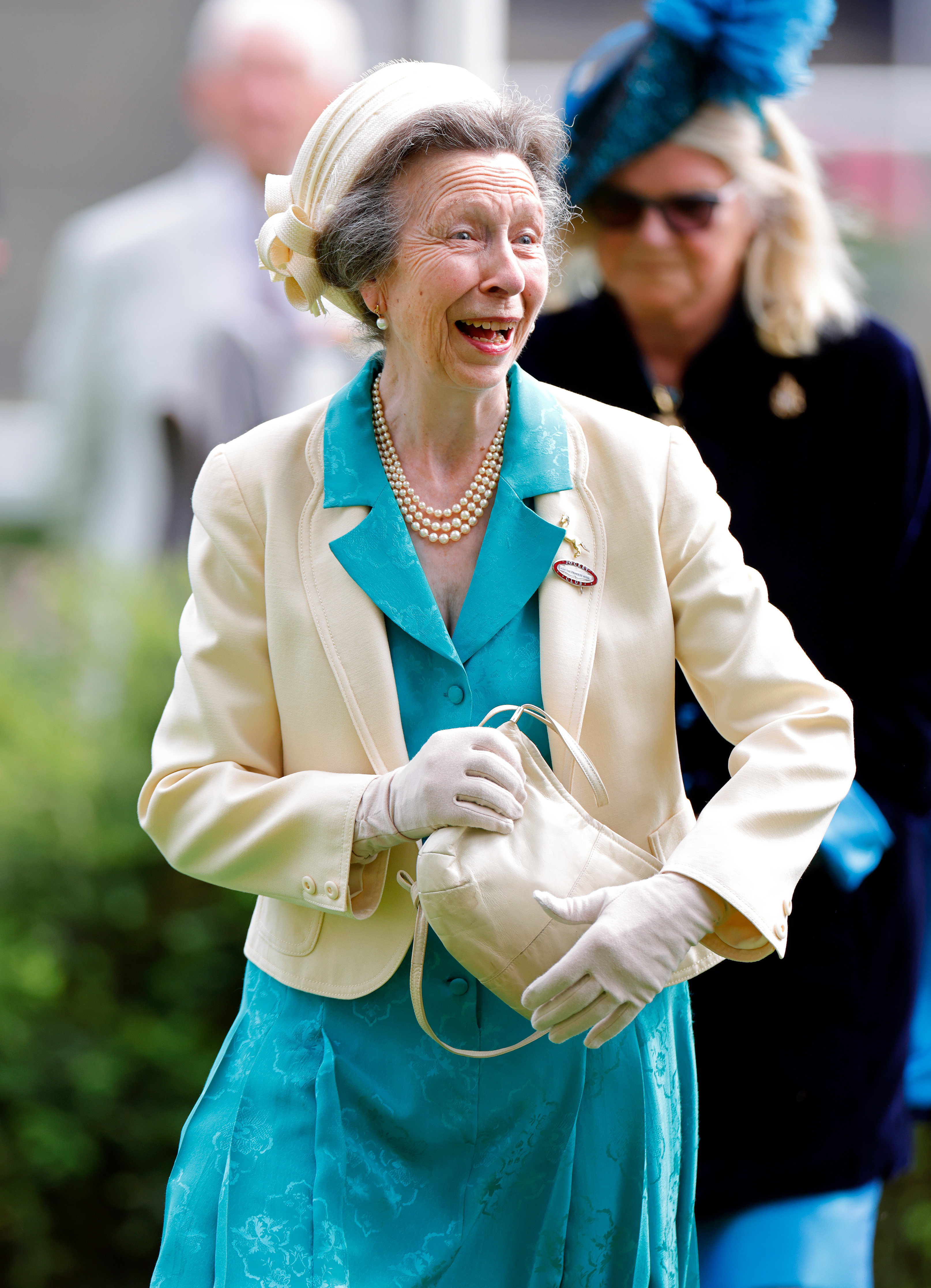 Princess Anne wearing a teal dress and laughing