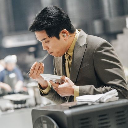 'Culinary Class Wars' judge Ahn Sung-jae tastes a dish, in a still from season 2.