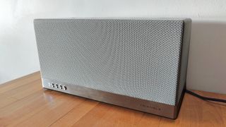 Triangle AIO3 (2022) review: grey speaker by a white wall