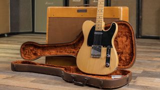 A Fender Nocaster rests in its case against a Fender Twin tweed amplifier