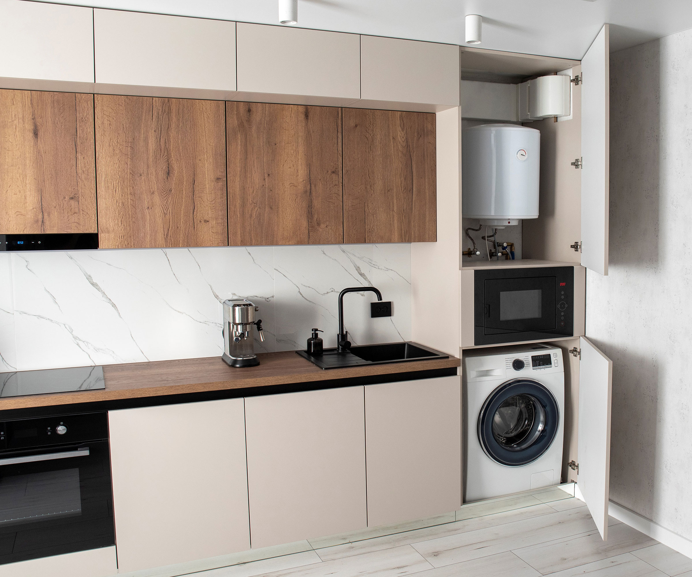 cream and wood kitchen with washing machine and boiler in kitchen cupboard