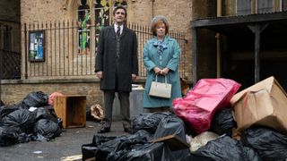 Doctor Turner and Violet look at a street covered in rubbish with upset faces