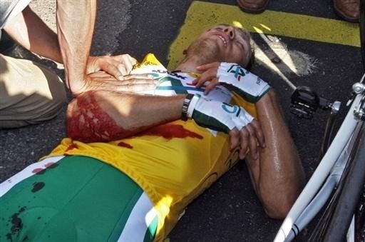 Thor Hushovd (CA) lies on the ground after having his arm cut by a spectator at the finish of stage 1