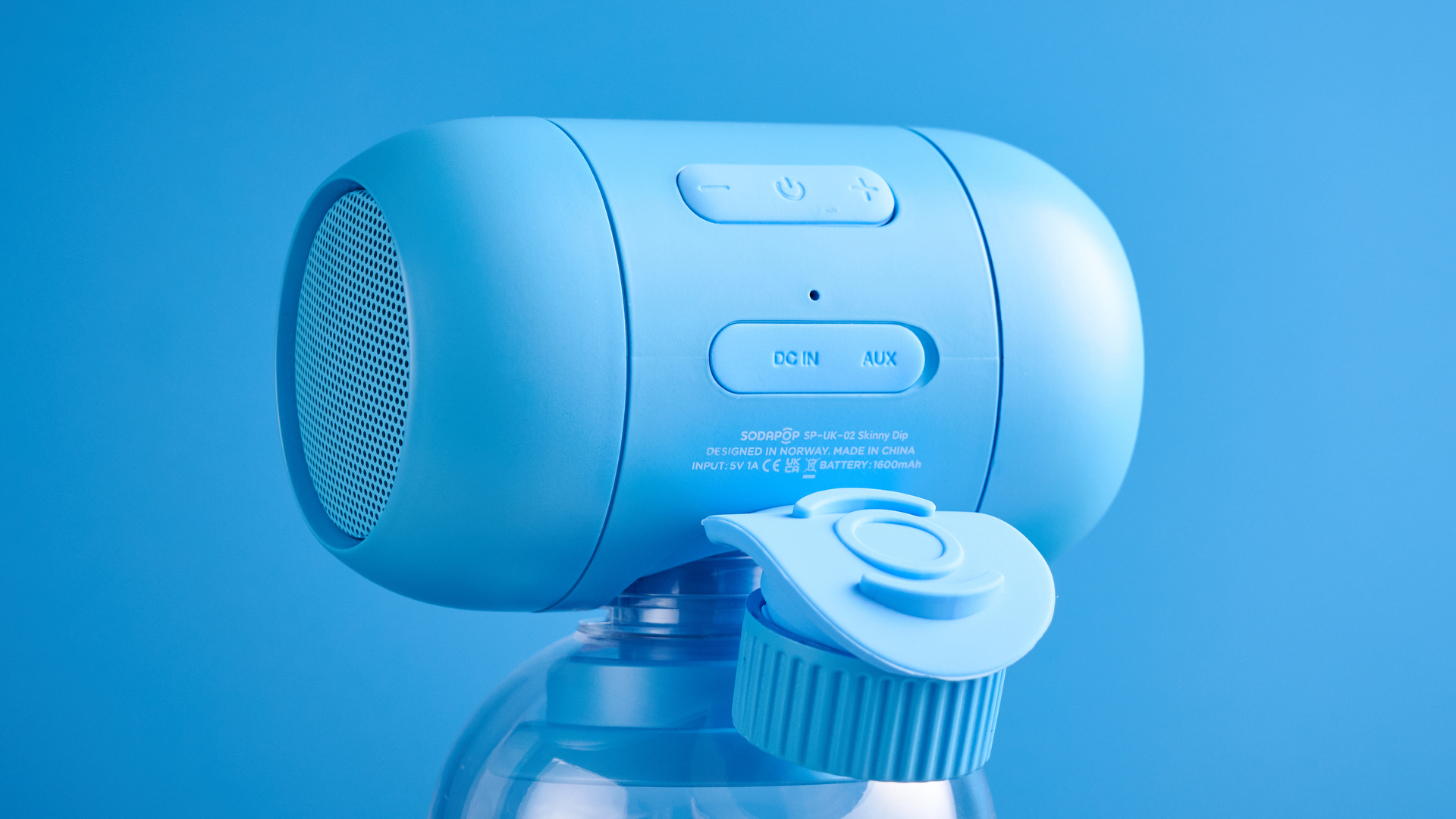 A blue Sodapop Bluetooth speaker that screws onto any regular-sized bottle