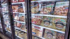 Frozen pizzas are seen in the aisle of a Publix grocery store in Surfside, Florida. 