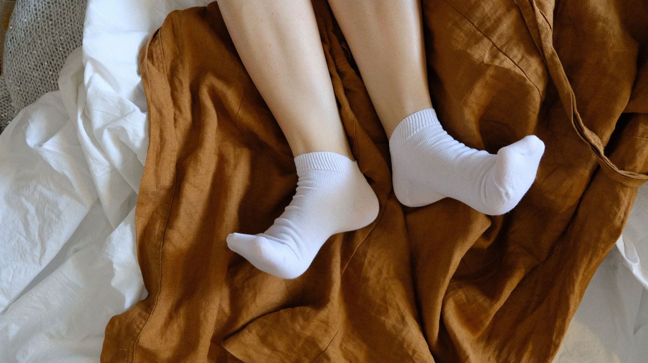 person wearing socks in bed