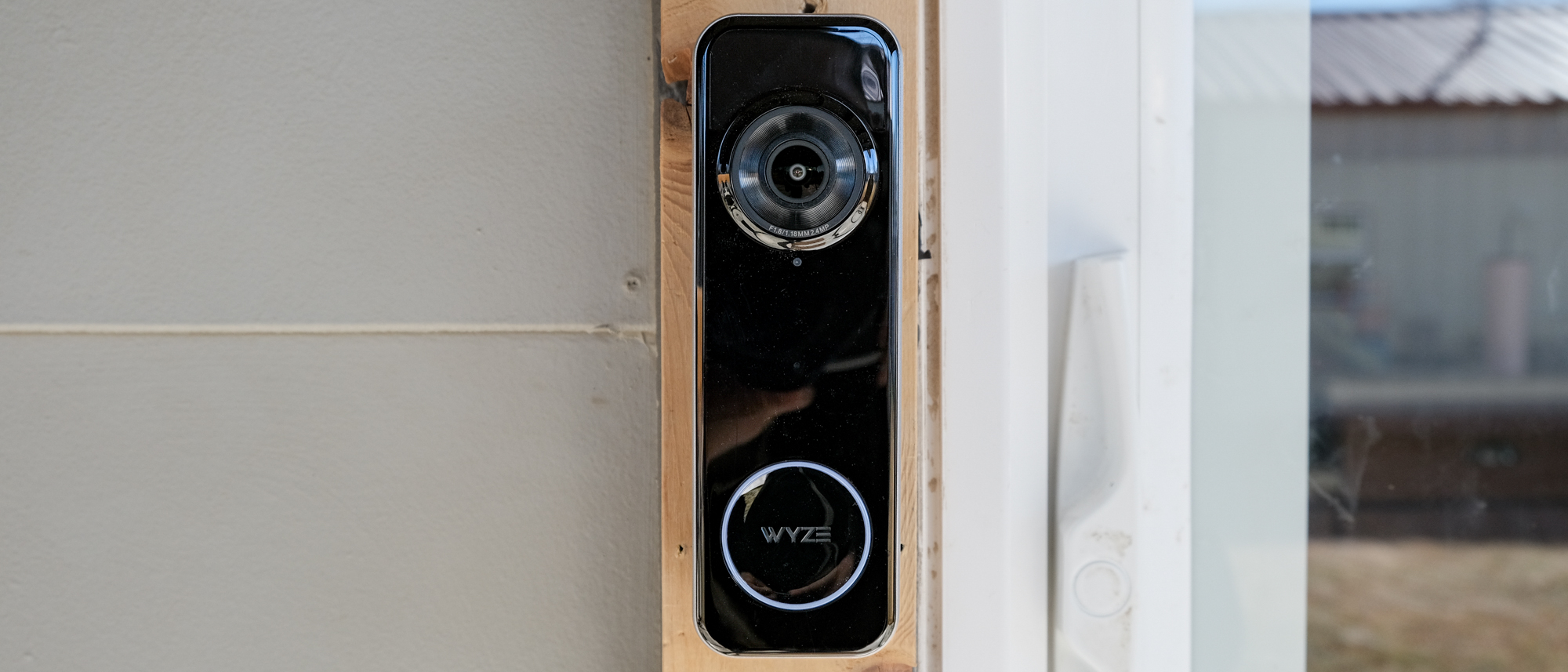 A Wyze Battery Video Doorbell mounted on a door frame