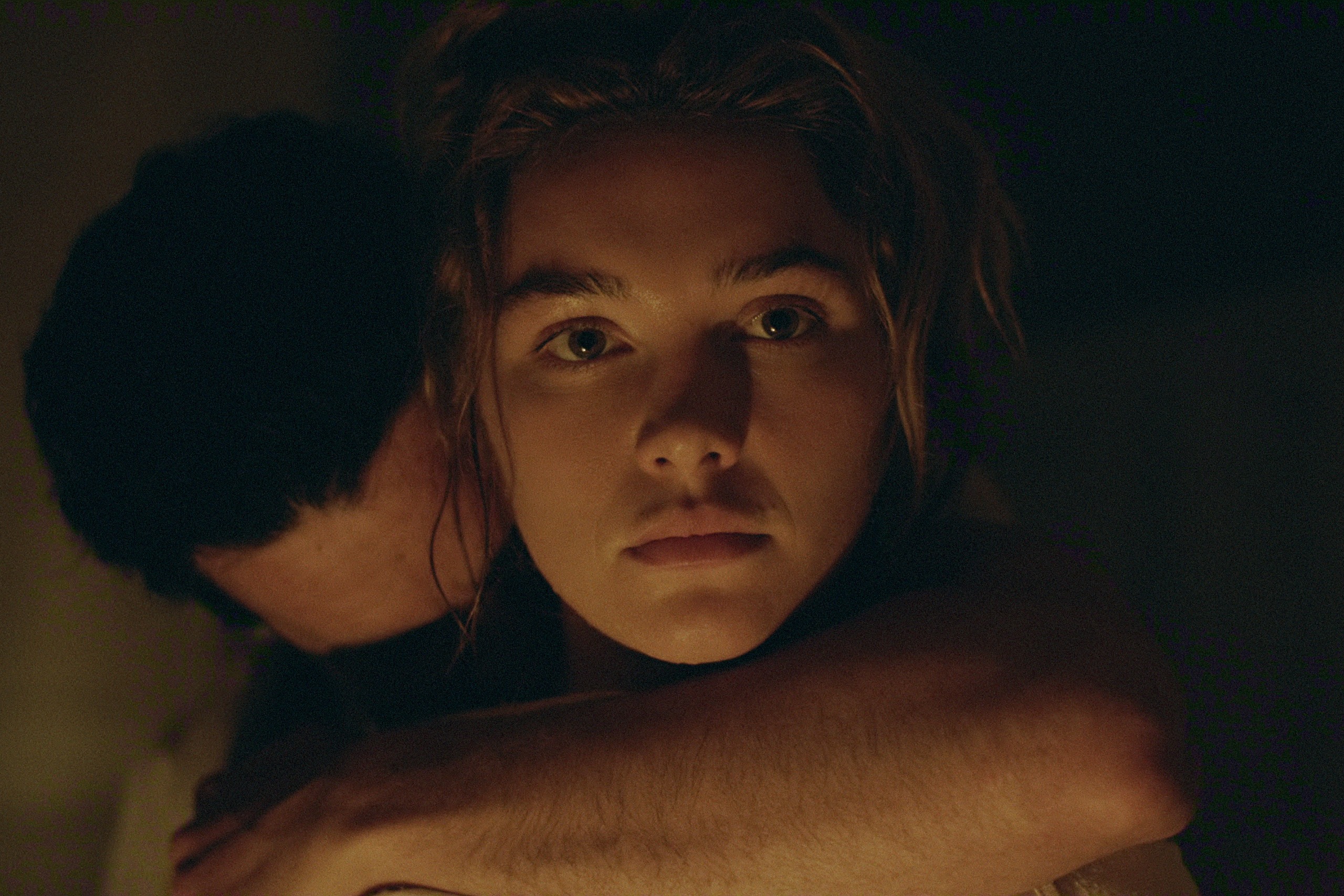 christopher abbott as adam hugs florence pugh as cathy from behind as she looks disaffected in east of eden