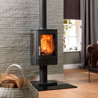 ACR-Neo woodburning stove in a living room with grey, exposed brick walls